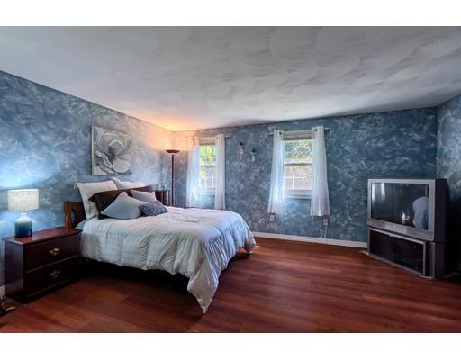 55 Norris Road Tyngsborough, MA 01879 - Photo 15 of 29 a bedroom with a bed and a fireplace