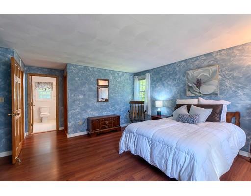 55 Norris Road Tyngsborough, MA 01879 - Photo 16 of 29 a bedroom with a bed windows and a fireplace