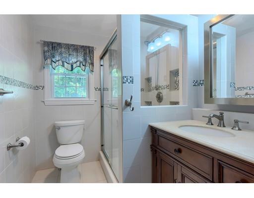 55 Norris Road Tyngsborough, MA 01879 - Photo 17 of 29 a bathroom with a granite countertop toilet a sink a mirror and a window