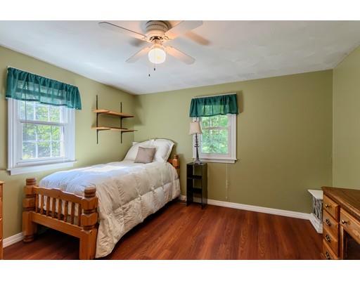 55 Norris Road Tyngsborough, MA 01879 - Photo 21 of 29 a bedroom with a bed and a chandelier