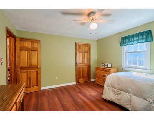 55 Norris Road Tyngsborough, MA 01879 - Photo 22 of 29 a bedroom with a bed and a chandelier