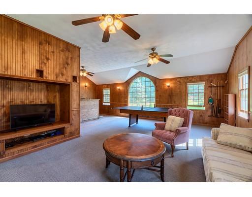 55 Norris Road Tyngsborough, MA 01879 - Photo 26 of 29 a living room with furniture a fireplace and a flat screen tv