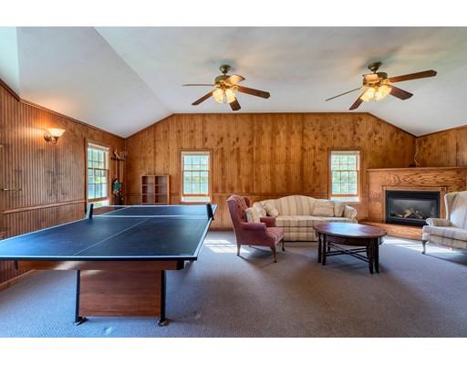 55 Norris Road Tyngsborough, MA 01879 - Photo 27 of 29 a living room with furniture a table and a fireplace