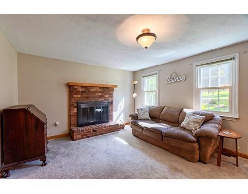 55 Norris Road Tyngsborough, MA 01879 - Photo 10 of 29 a living room with furniture and a fireplace