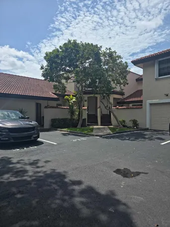 a view of a car park in front of a house