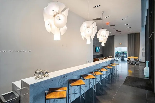 an entryway with wooden floor and a chandelier