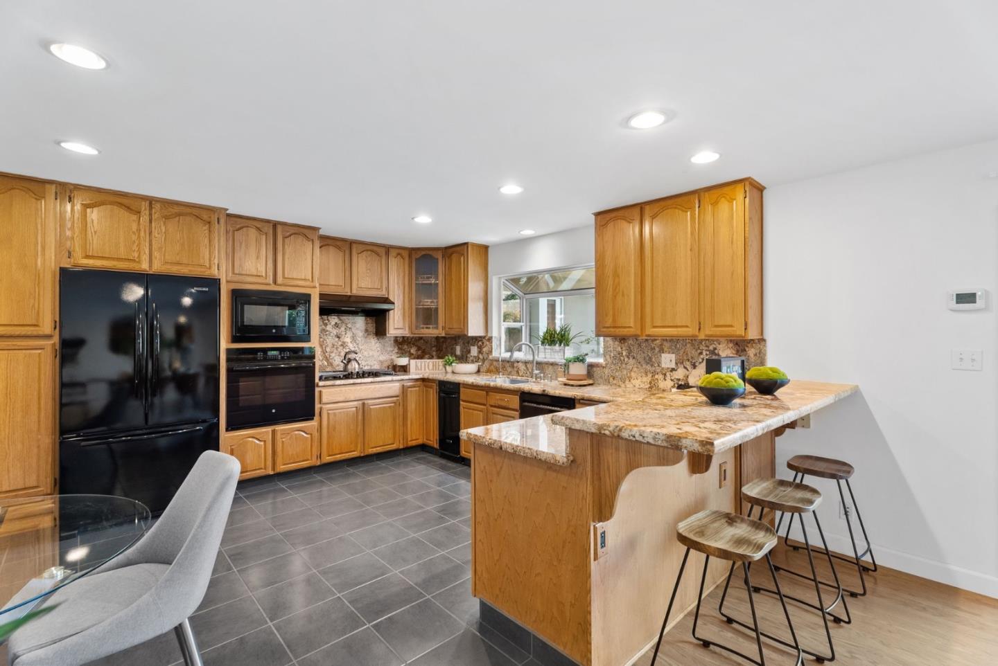 1081 Rockefeller Drive Sunnyvale, CA 94087 - Photo 10 of 24 a kitchen with stainless steel appliances a table and chairs