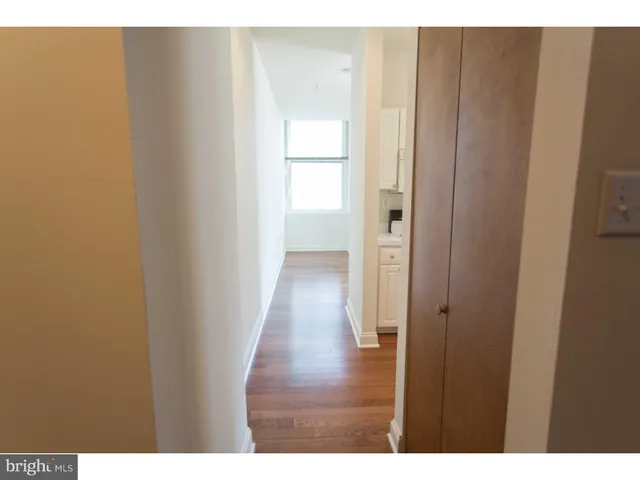 a view of an empty room and wooden floor