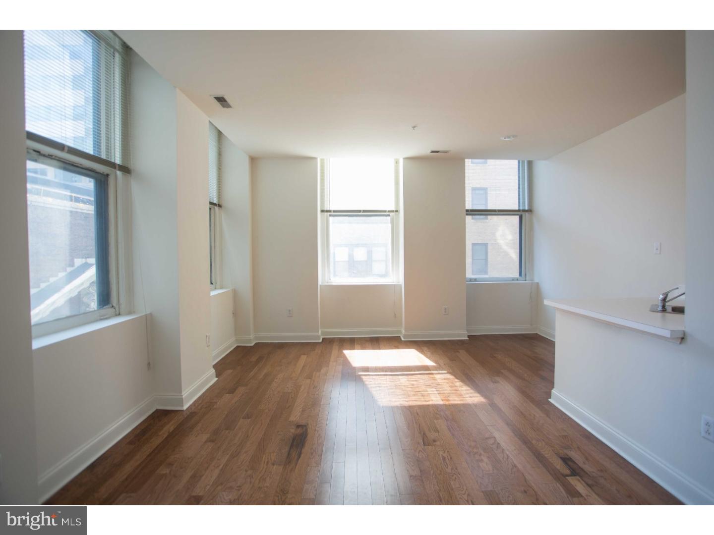 1600-3 Walnut Street, Unit 902 Philadelphia, PA 19103 - Photo 8 of 25 a view of an empty room with wooden floor and a window