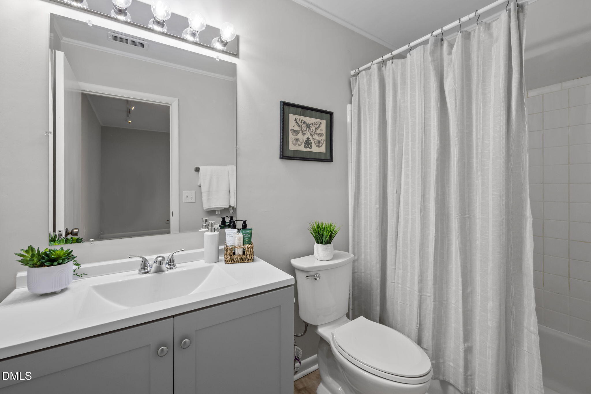 3080 Colony Road, Unit 3080C Durham, NC 27705 - Photo 23 of 57 a bathroom with a sink a mirror and a toilet