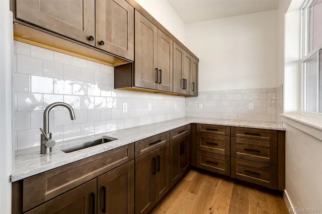 a kitchen with stainless steel appliances granite countertop a sink and a stove