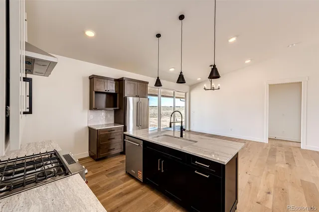a kitchen with a sink stove and refrigerator