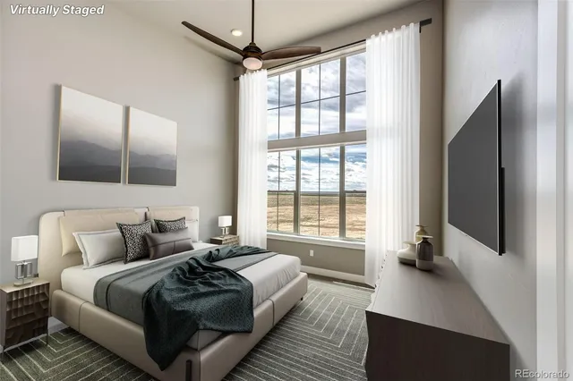 a bedroom with a bed and a flat tv screen on the dresser