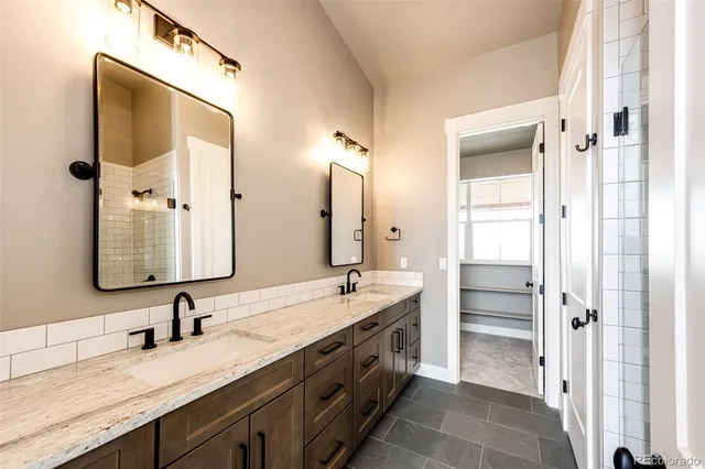 a spacious bathroom with a double vanity sink and mirror