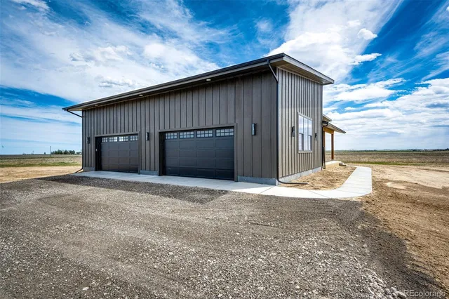 a view of a house with a yard and garage