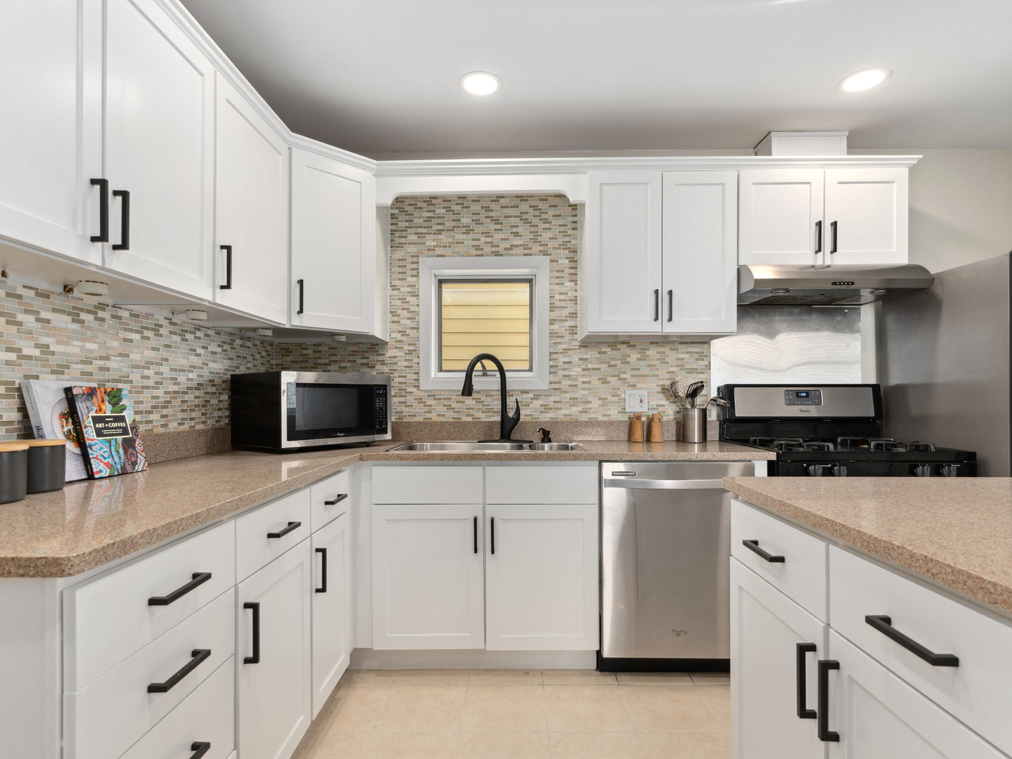 3034 North Seminary Avenue, Unit 2 Chicago, IL 60657 - Photo 16 of 26 a kitchen with white cabinets sink and stainless steel appliances