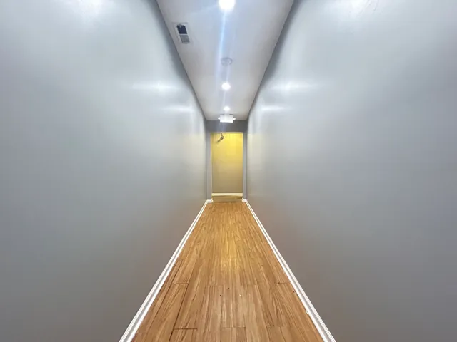 a view of gallery with wooden floor