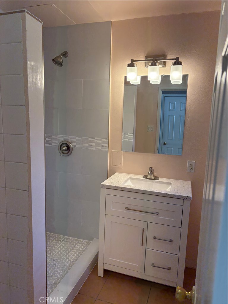 28 Paradise Valley North Carson, CA 90745 - Photo 15 of 17 a bathroom with a double vanity sink and mirror with shower