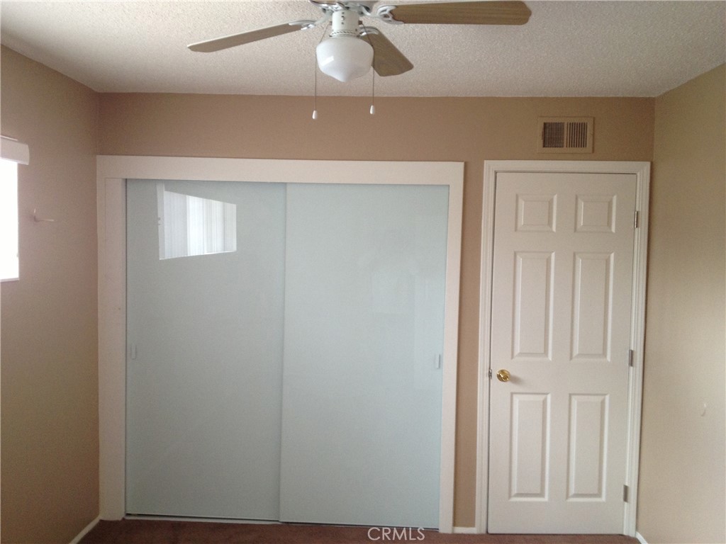 28 Paradise Valley North Carson, CA 90745 - Photo 5 of 17 an empty room with a ceiling fan