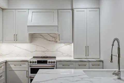 a stove top oven sitting inside of a kitchen