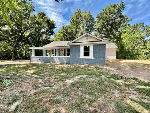 a front view of a house with a garden