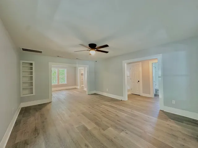 wooden floor in an empty room with a window