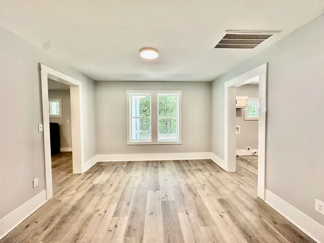 wooden floor in an empty room with a window