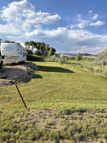 547 East 2000th Street North Vernal, UT 84078 - Photo 37 of 50 Expansive grassy area with distant rolling hills and a varied tree line