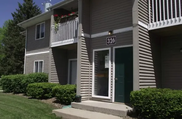 a view of a house with a door and a yard