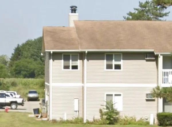 a view of a house with a yard and sitting area