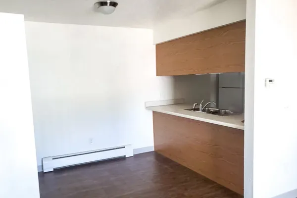 a kitchen with a refrigerator and a stove