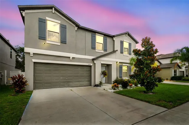 a front view of a house with a yard and garage