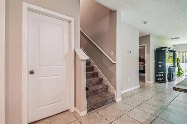 a view of a hallway with entryway and stairs