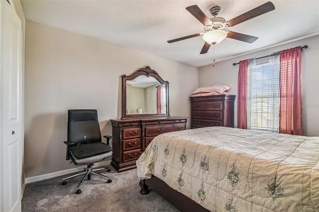 a bedroom with a bed dresser and a window