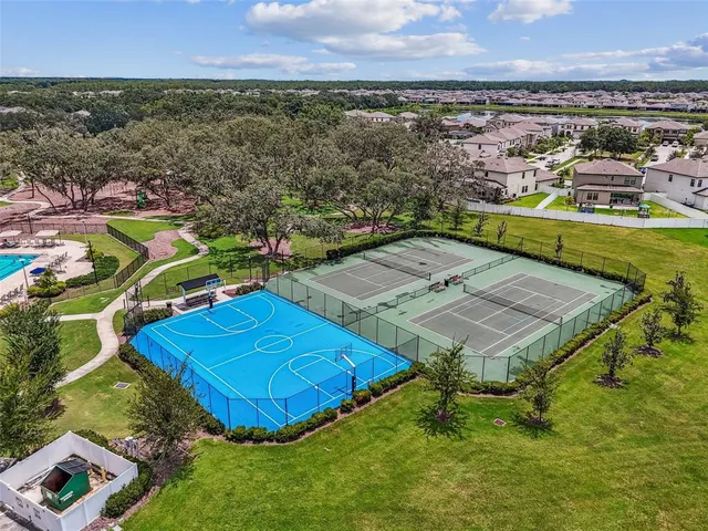 an aerial view of residential houses with outdoor space and swimming pool