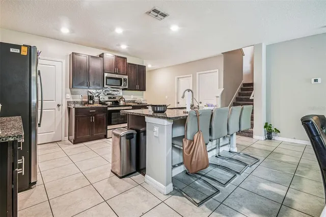 a kitchen with stainless steel appliances granite countertop a sink and a stove