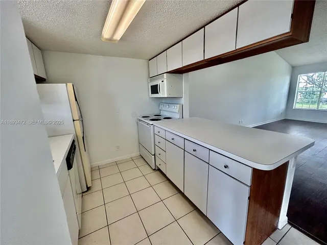 a kitchen with stainless steel appliances a sink and cabinets