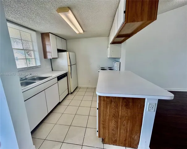 a kitchen with stainless steel appliances a stove sink and cabinets
