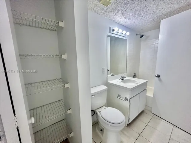 a utility room with cabinets washer and dryer