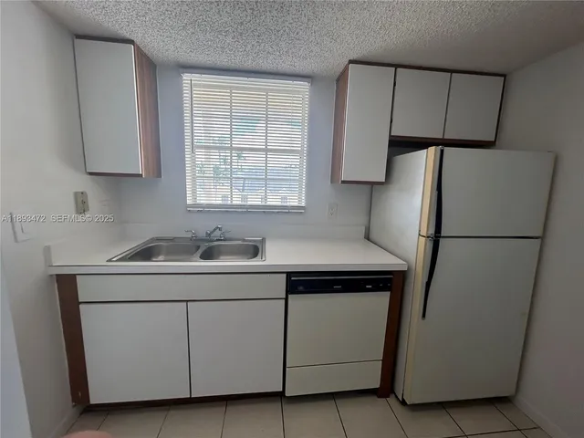 a front view of a house with a yard and many windows