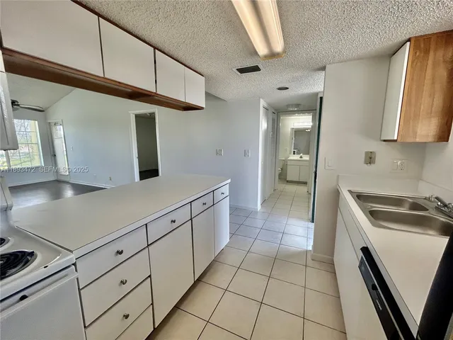 a kitchen with cabinets and a stove