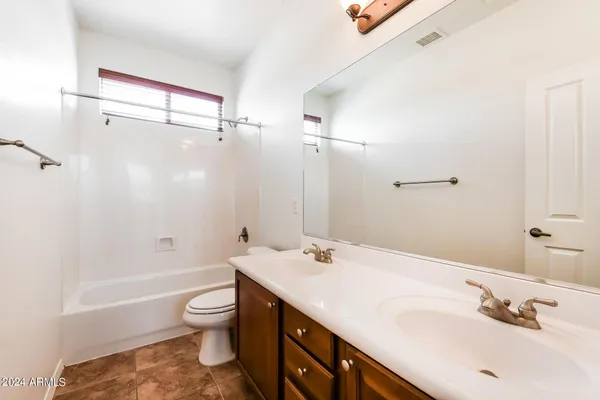 a bathroom with a double vanity sink toilet and shower