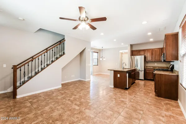 a view of kitchen with stainless steel appliances refrigerator stove microwave and cabinets