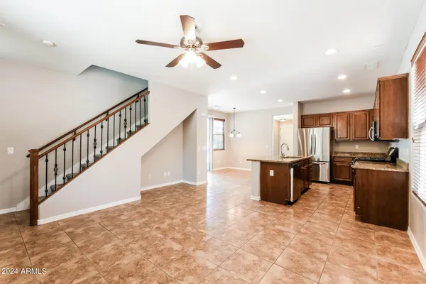 a view of kitchen with stainless steel appliances cabinets and a ceiling fan