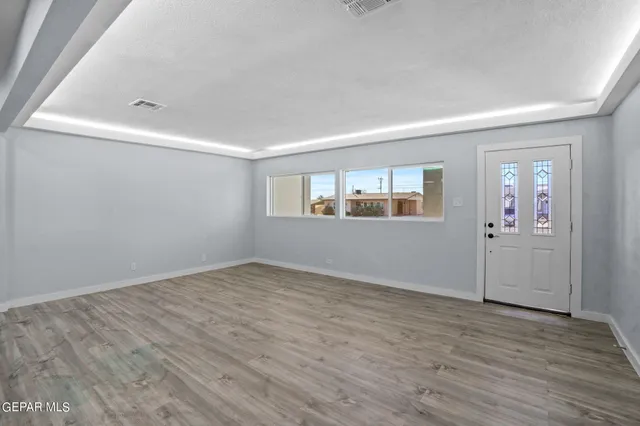 wooden floor in an empty room with a window