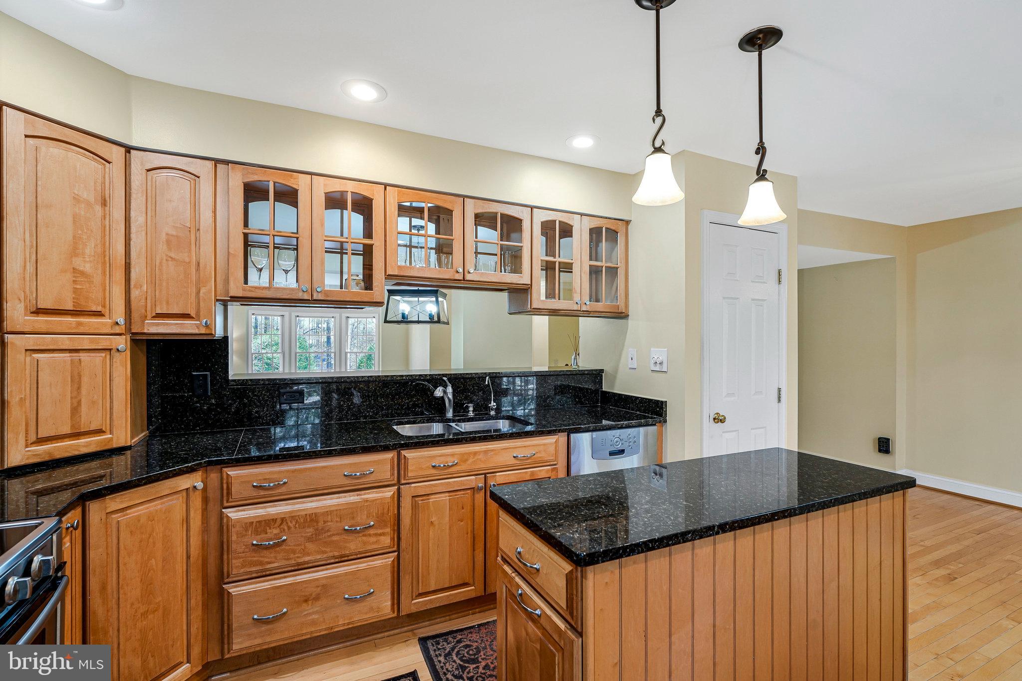 6556 Antrican Drive Springfield, VA 22150 - Photo 12 of 36 a kitchen with granite countertop a stove a sink and a granite counter tops
