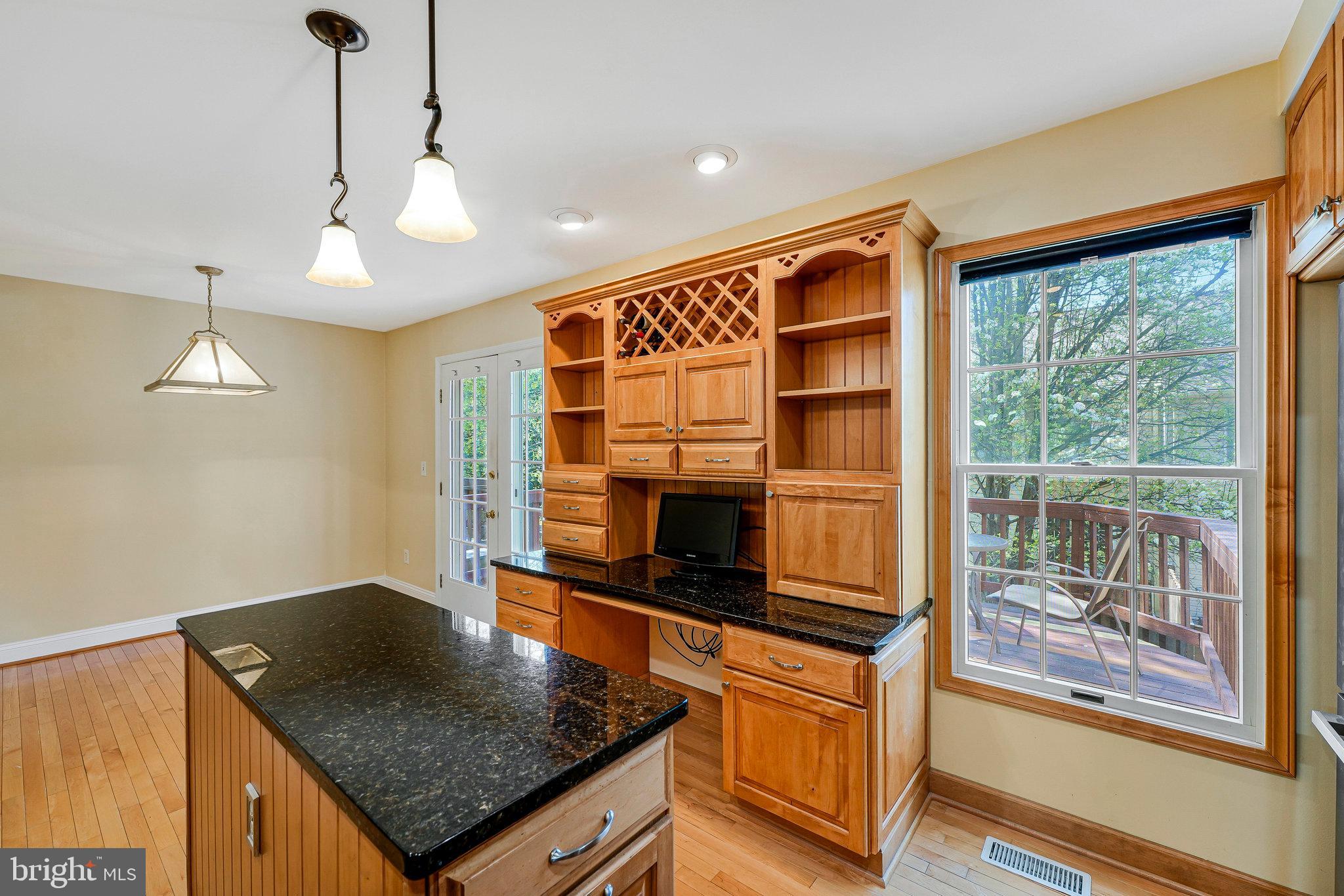 6556 Antrican Drive Springfield, VA 22150 - Photo 13 of 36 a kitchen with stainless steel appliances granite countertop a stove a sink and a refrigerator
