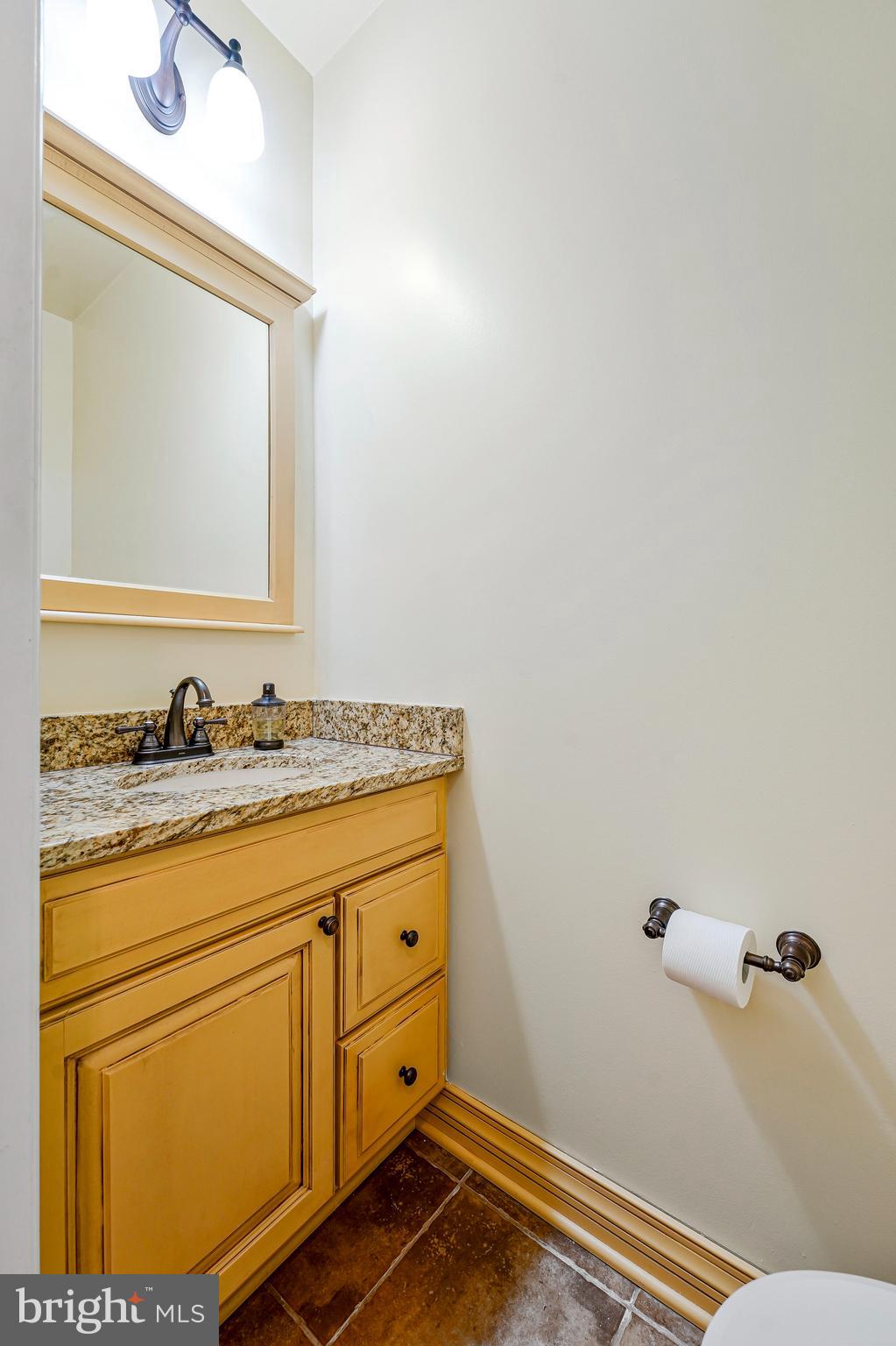 6556 Antrican Drive Springfield, VA 22150 - Photo 16 of 36 a bathroom with a granite countertop sink and a mirror