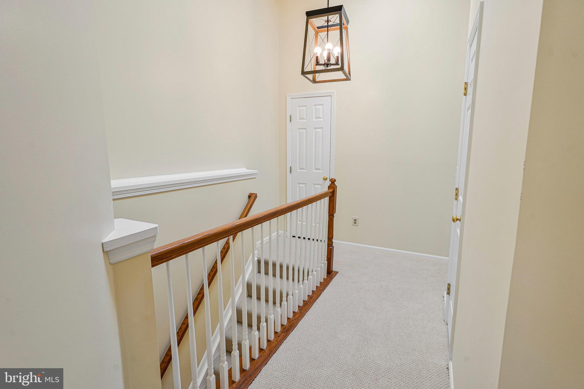 6556 Antrican Drive Springfield, VA 22150 - Photo 17 of 36 a view of a hallway with white walls
