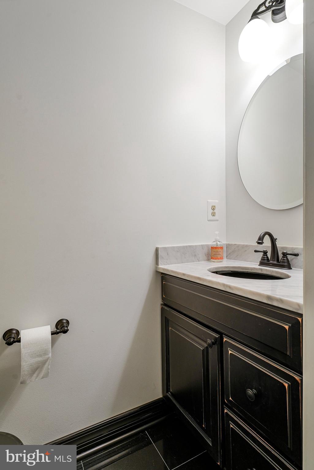 6556 Antrican Drive Springfield, VA 22150 - Photo 29 of 36 a bathroom with a sink and a mirror